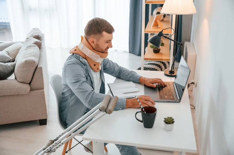 Person with mobility aids and neck brace demonstrating how disability coverage can help maintain financial stability.