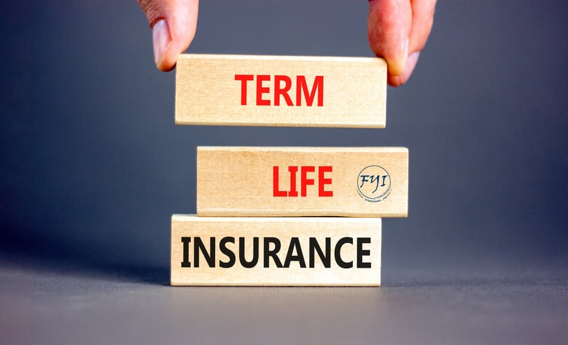 Wooden blocks labeled “Term Life Insurance” stacked together, with a hand adjusting the top block, symbolizing the building blocks of affordable, temporary life coverage. The FYI (FYInsurance Solutions) logo represents trusted California-based insurance guidance.